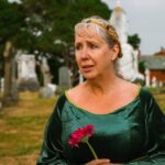 woman_in_green_dress_with_pink_flower